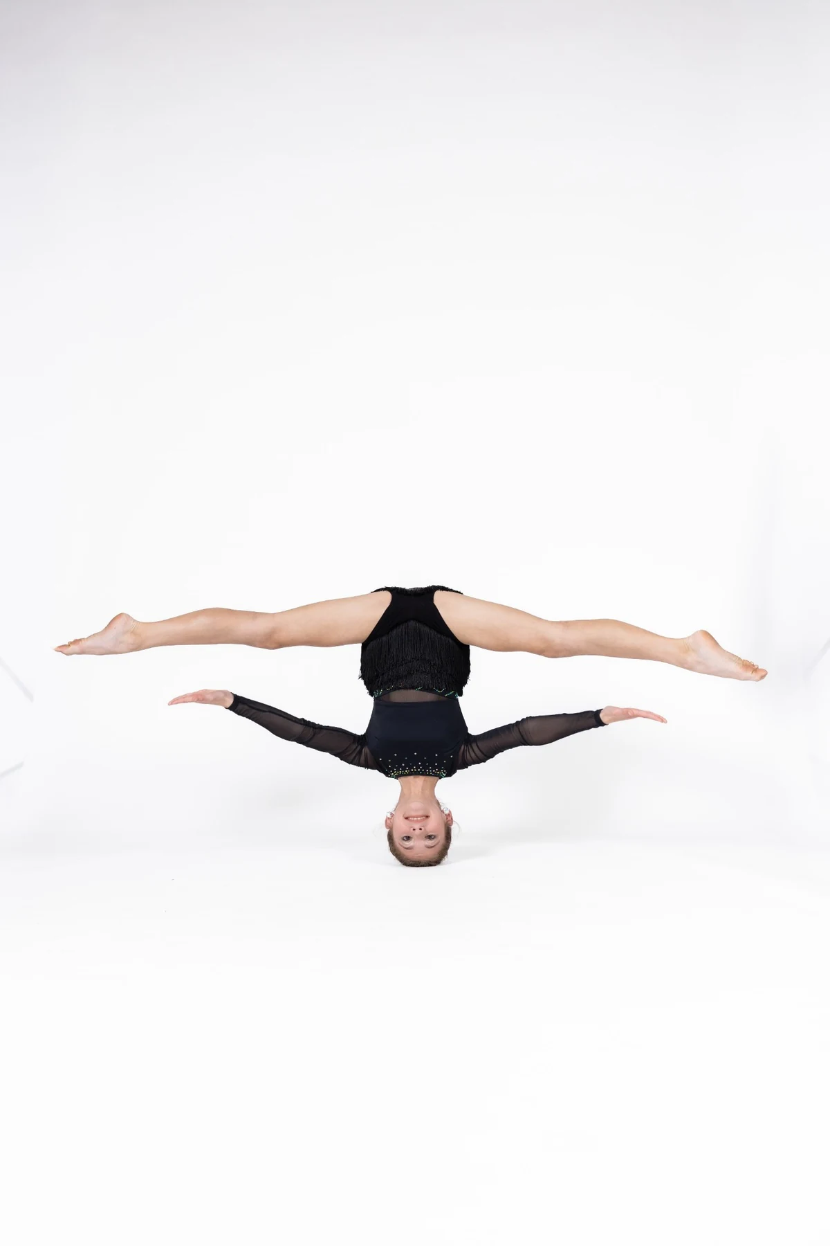 Acrobatics dancer performing a controlled headstand split
