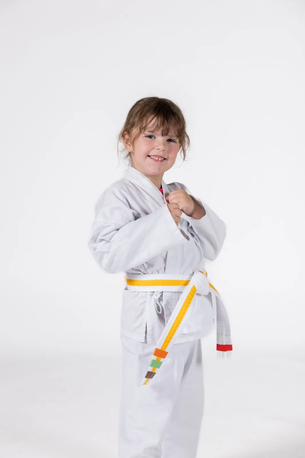 Young martial arts student in a white uniform