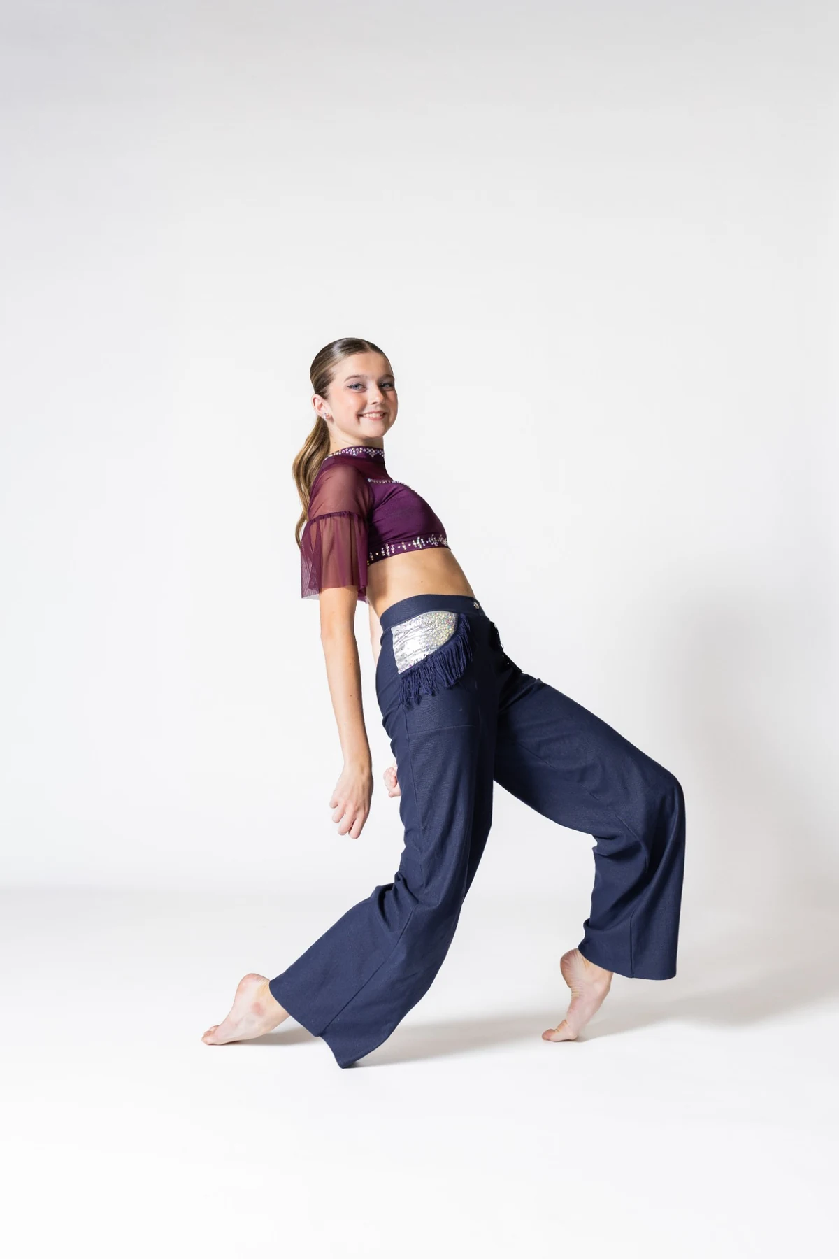 Teen dancer in a purple and navy costume