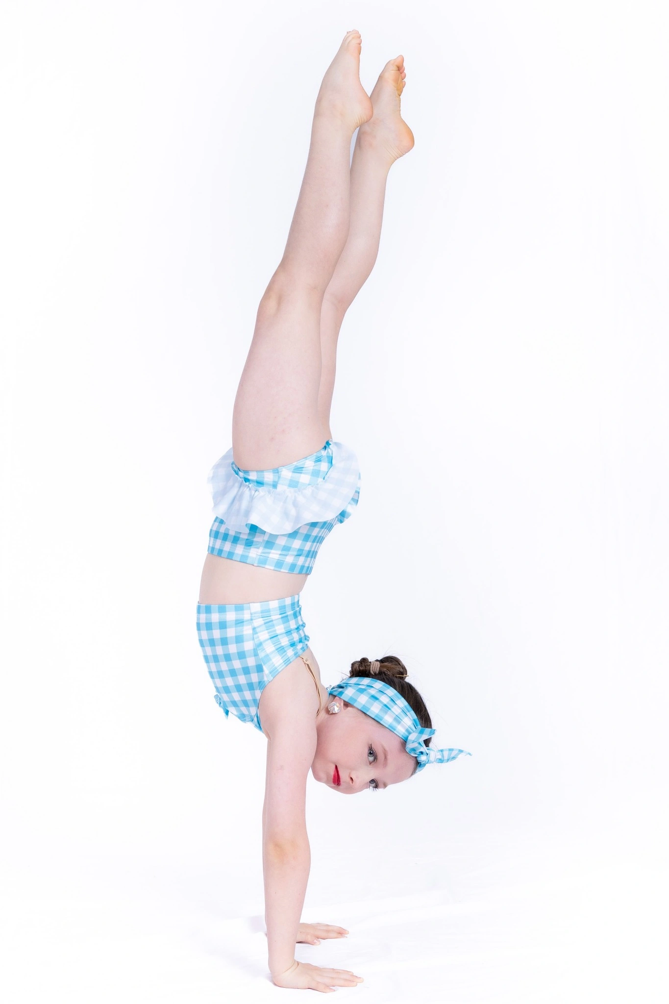 Young acrobatics dancer holding a confident handstand